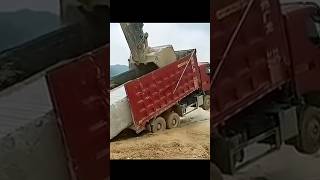 The process of loading a stone block onto a truck body using an excavator [upl. by Cynthea]