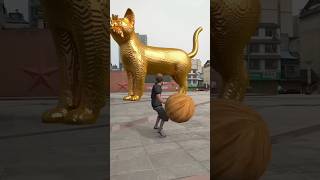 A boy throws a ball to unblock the golden statue of the big cat in the square Original golden stat🐱 [upl. by Torrell]