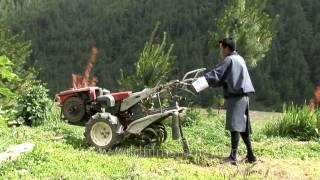 Bhutanese farmer moving a power tiller in Bumthang District of Bhutan [upl. by Notnarb]