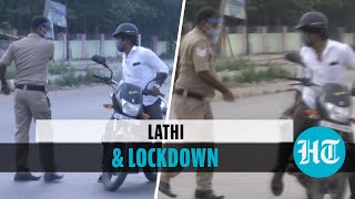 Watch Cop hits biker with lathi amid Covid lockdown in Karnataka [upl. by Sucramrej]