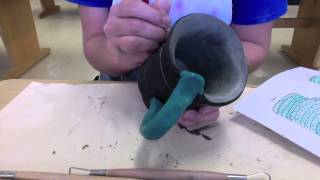 Underglazing a greenware mug and adding sgraffito designs [upl. by Ethyl]